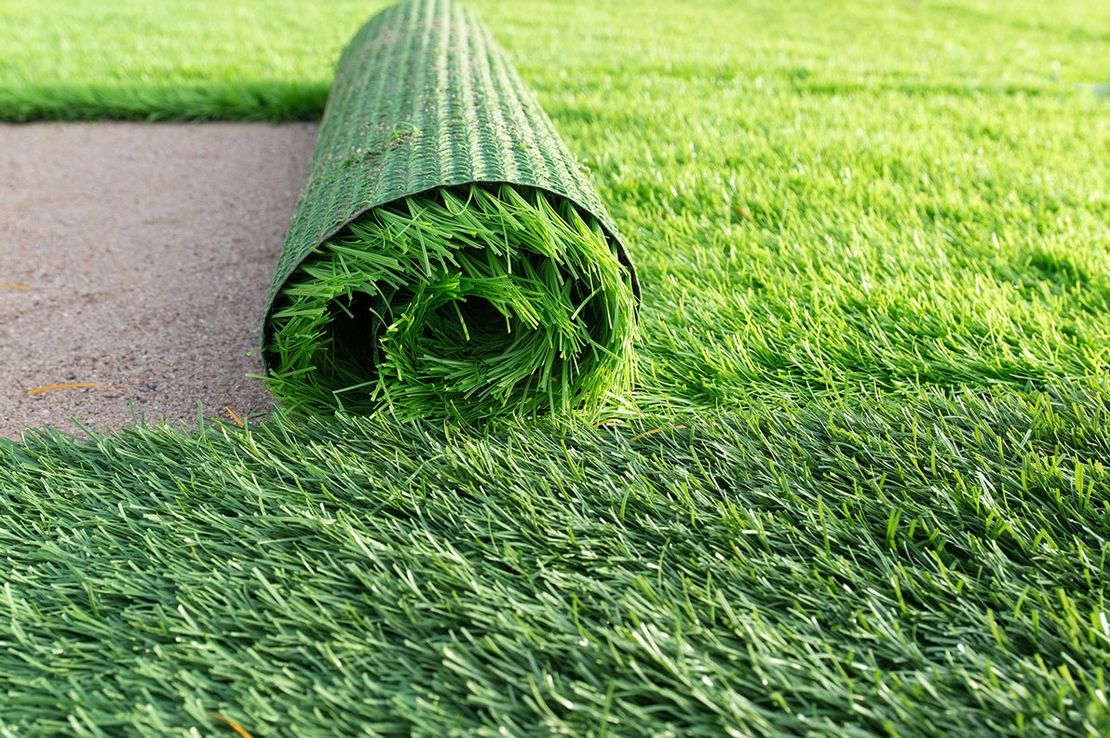 Artificial grass being laid in a garden